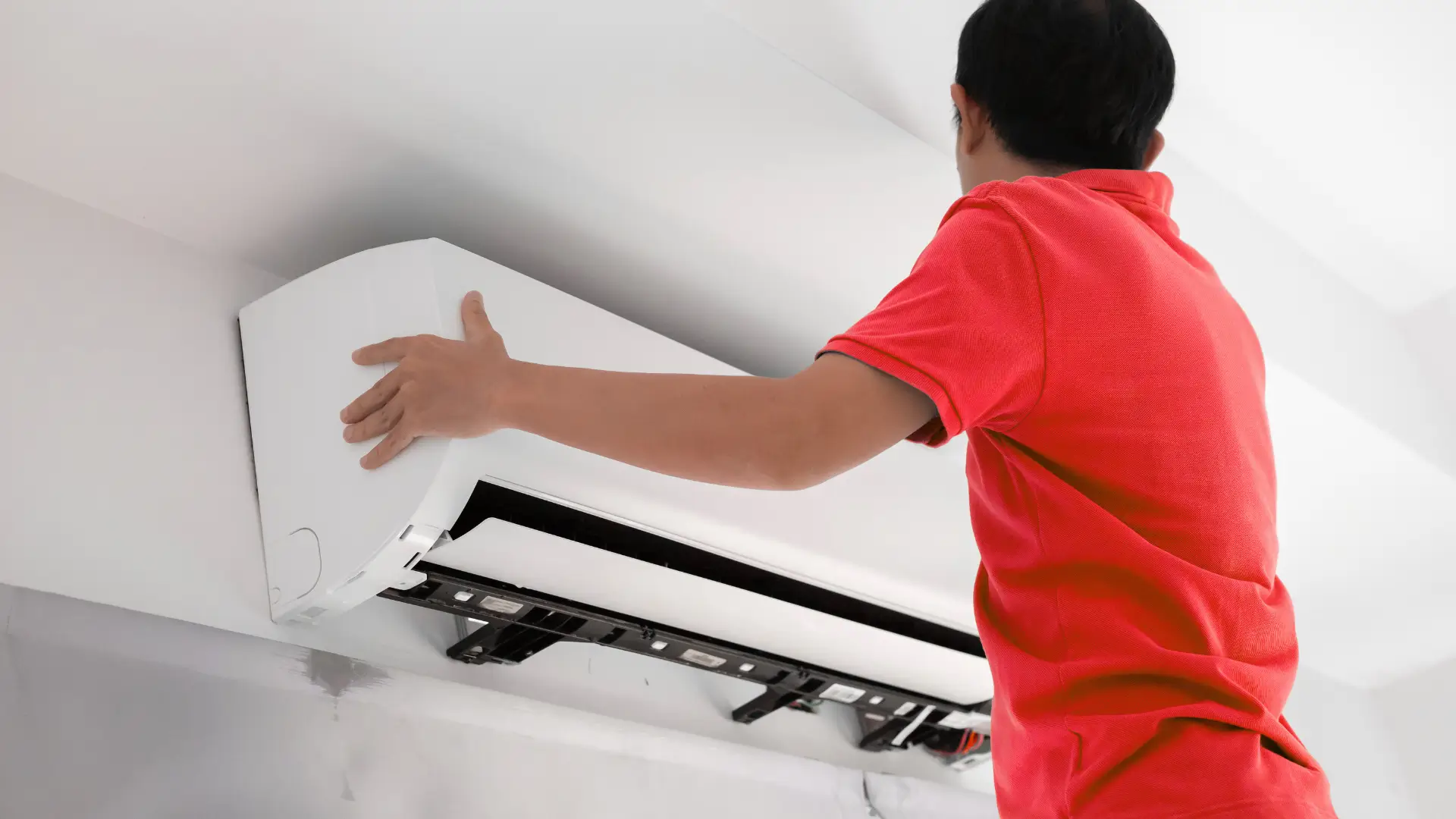 Technician cleaning AC filters during maintenance